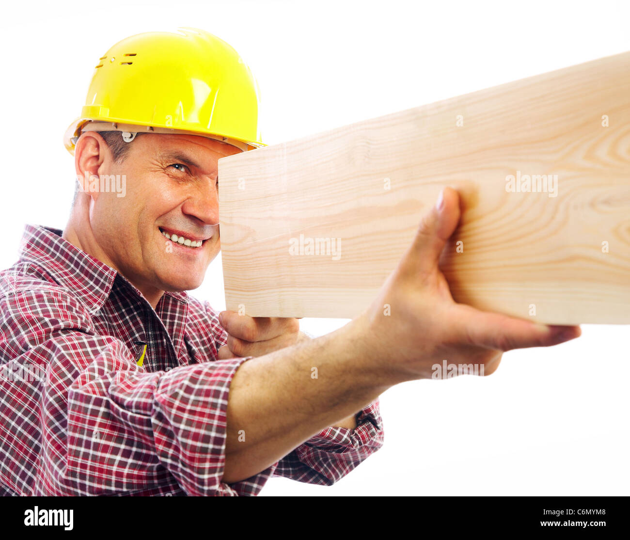 handsome skilful carpenter measures the board isolated on white background Stock Photo