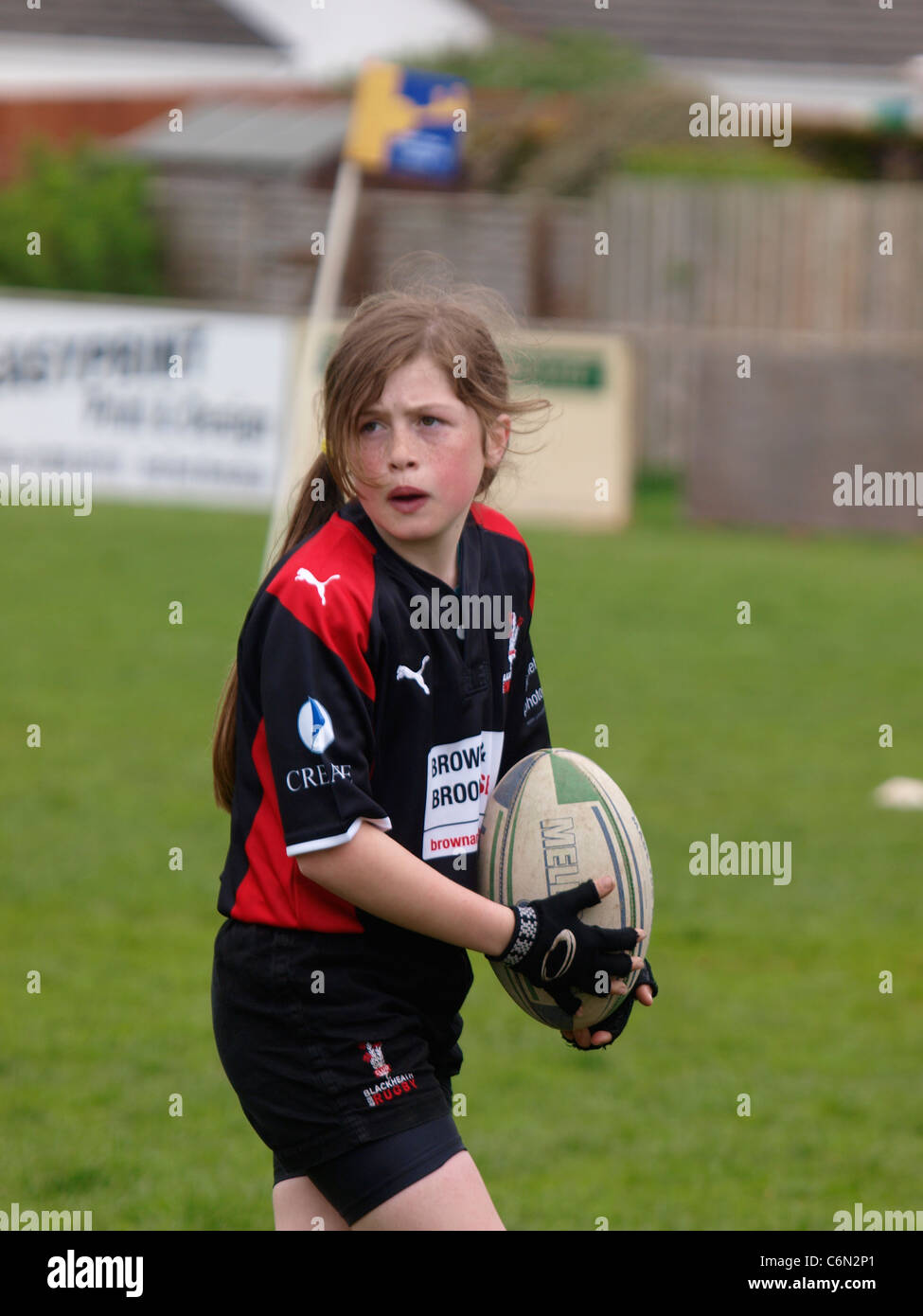 Young girl playing rugby, mini's festival of rugby Bude vs blackheath, Cornwall, UK Stock Photo