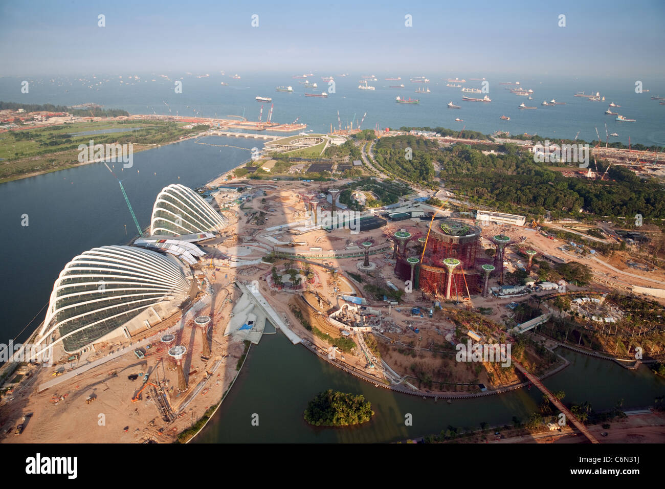 Land reclamation and new building in Singapore seen from the top of the Marina Bay Hotel (shadow of the hotel on the land) Stock Photo