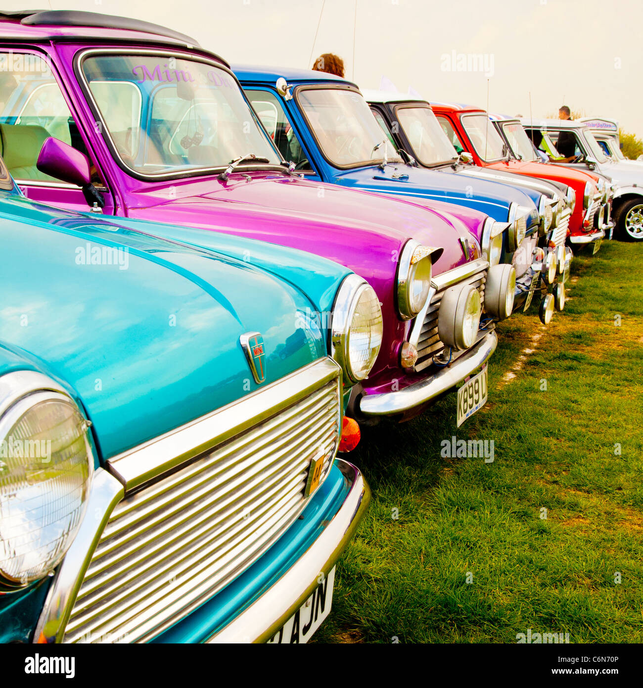 Row of brightly coloured minis at a car show Stock Photo