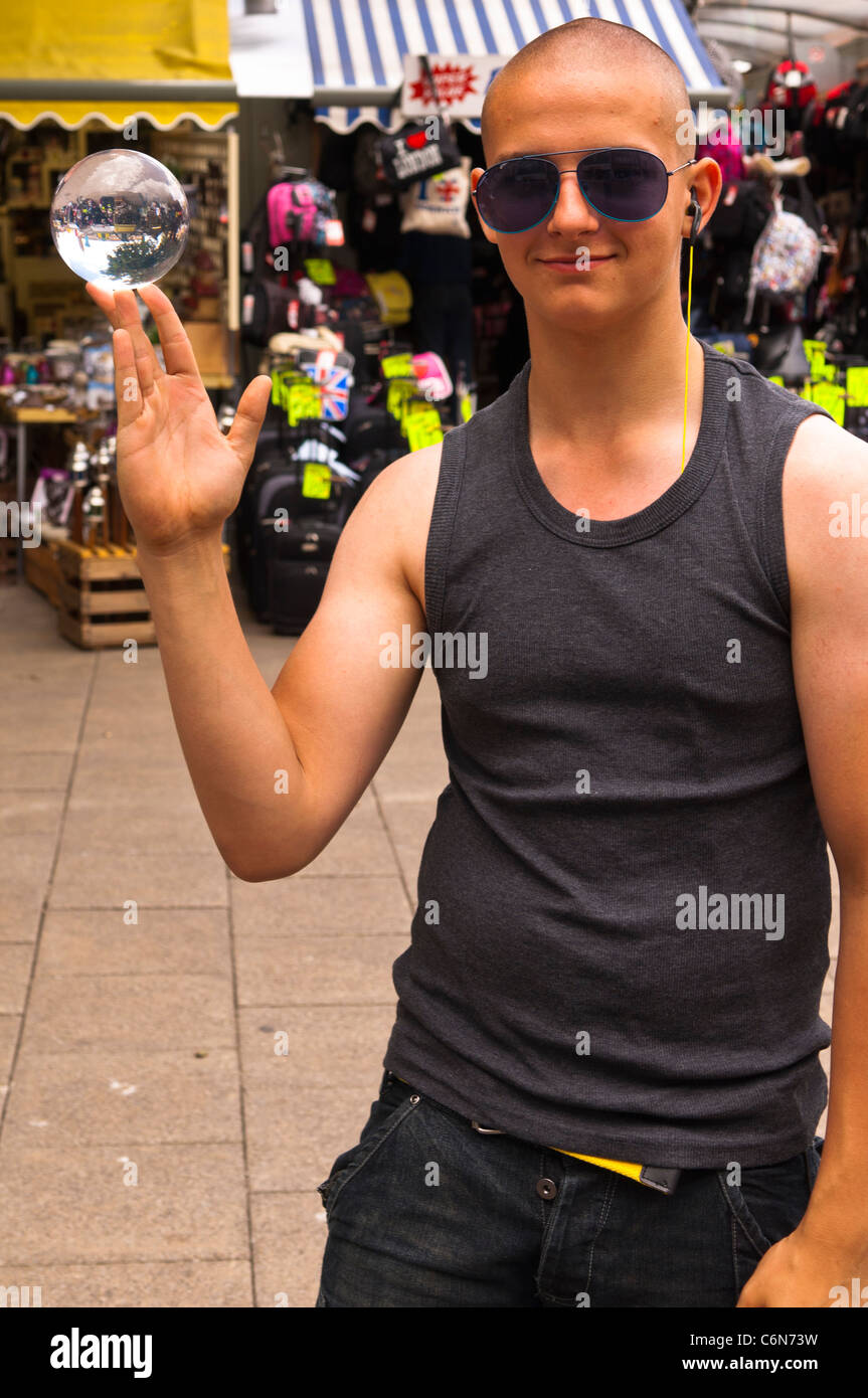 A street performer with his glass ball which he does tricks with in