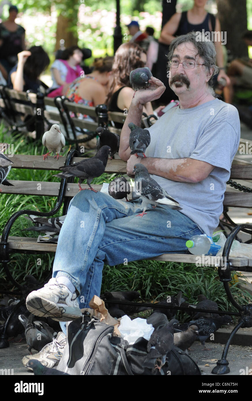 The Bird Whisperer shows kids how to handle pigeons on a sunny day in