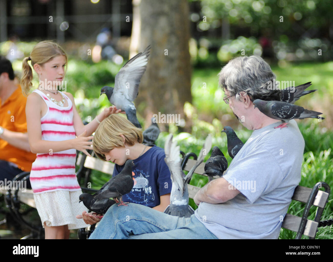The Bird Whisperer shows kids how to handle pigeons on a sunny day in