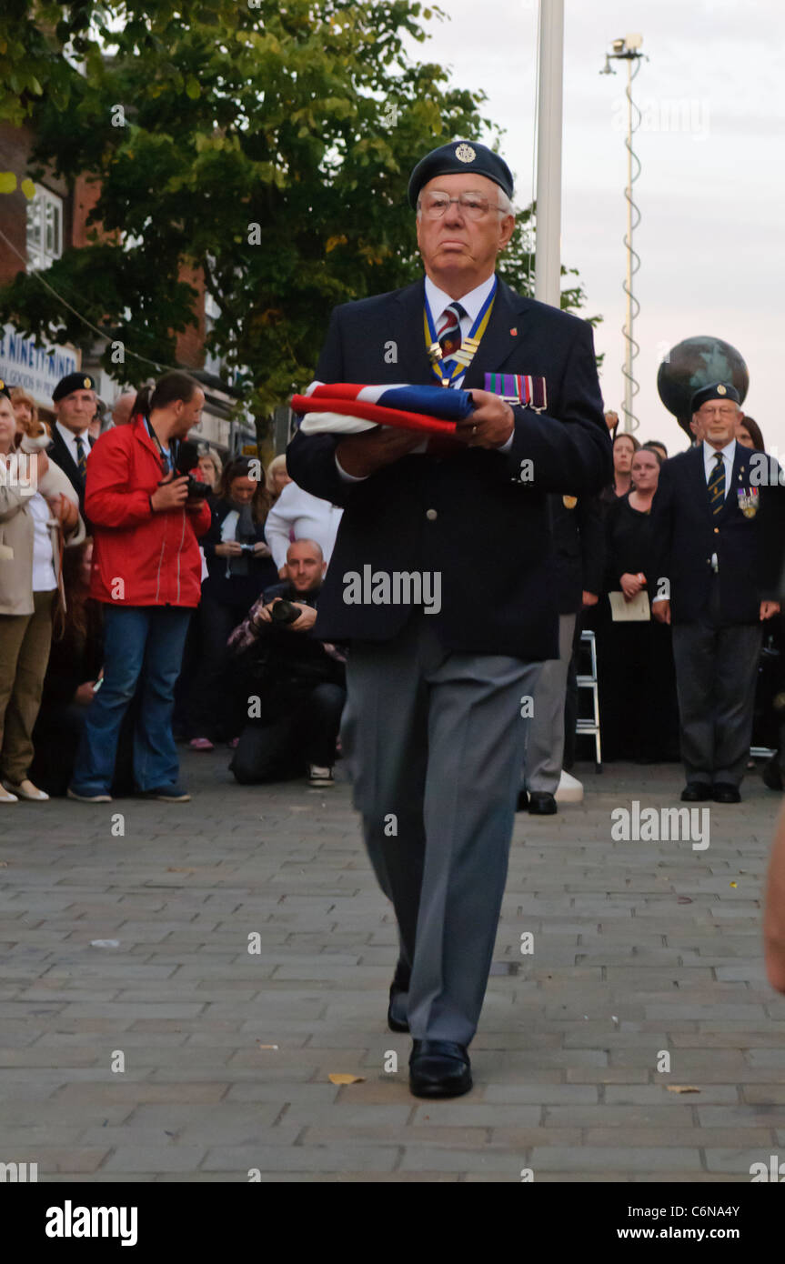 Chairman of the Royal British Legion carries a folded Union Flag during the Sunset Ceremony. Royal Wootton Bassett 31/08/2011 Stock Photo