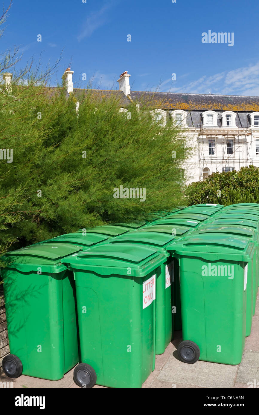 Green litter bins lined up ready to put out Stock Photo Alamy