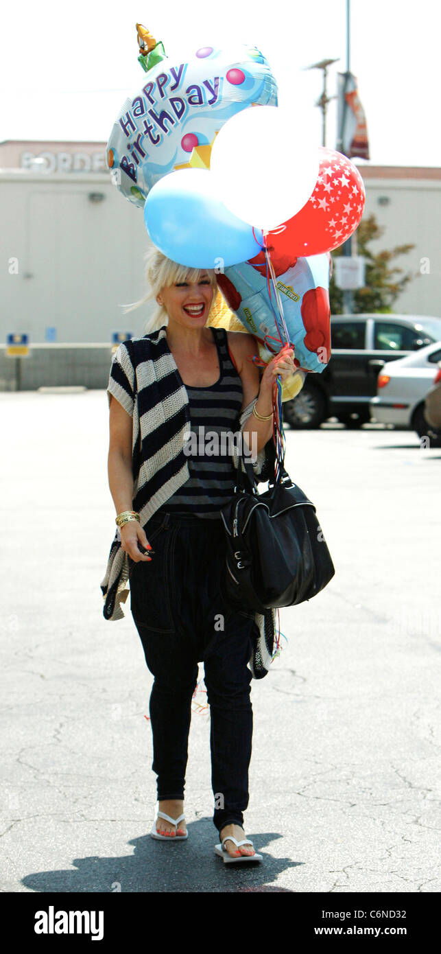 Gwen Stefani shopping at Party City in Hollywood with family holding a