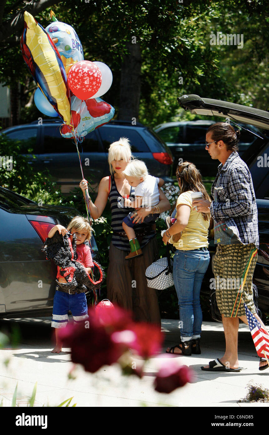 Gwen Stefani shopping at Party City in Hollywood with family holding a