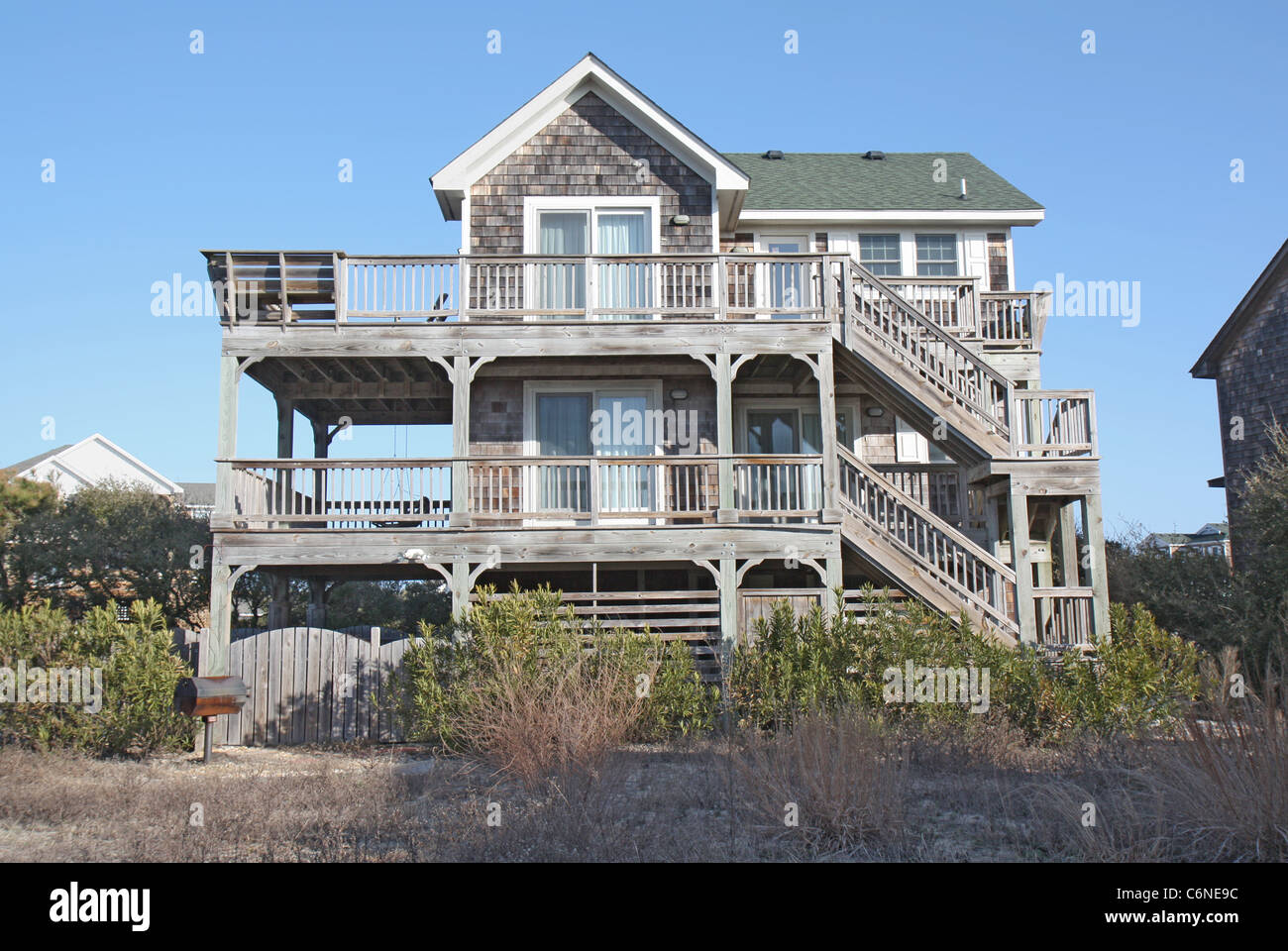 A beach house on the Outer Banks at Nags Head, North Carolina, against a bright blue sky Stock Photo