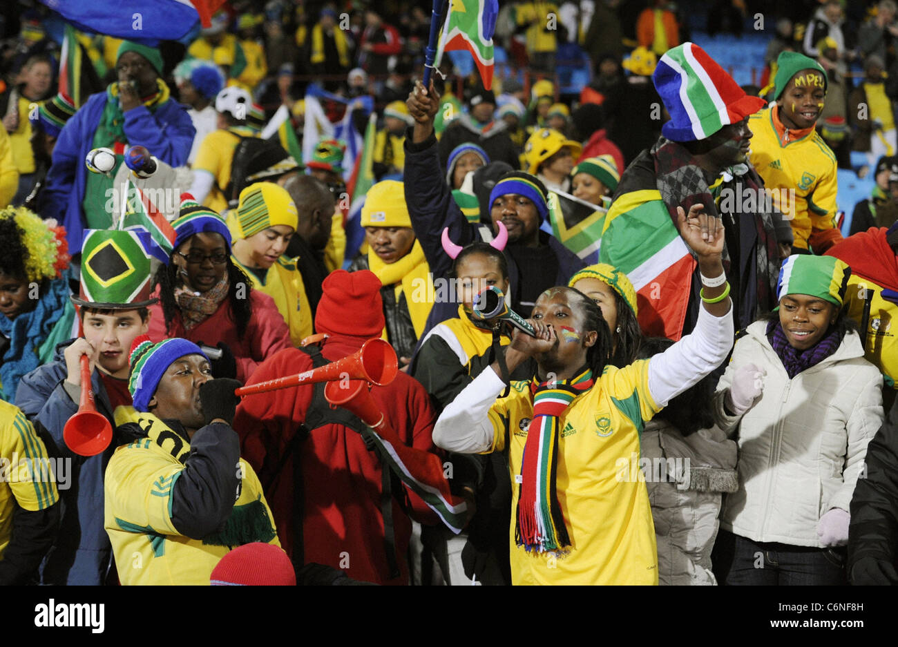 Supporters of the South Africa soccer team blow vuvuzela horns at