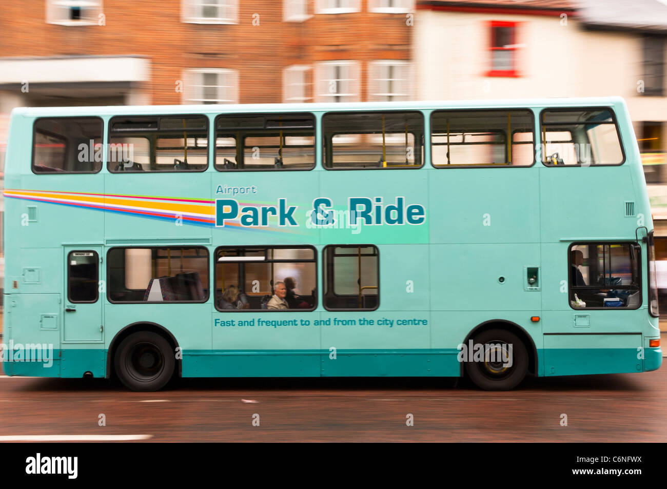A double decker bus drives through the city showing deliberate motion blur in Norwich , Norfolk , England , Britain , Uk Stock Photo