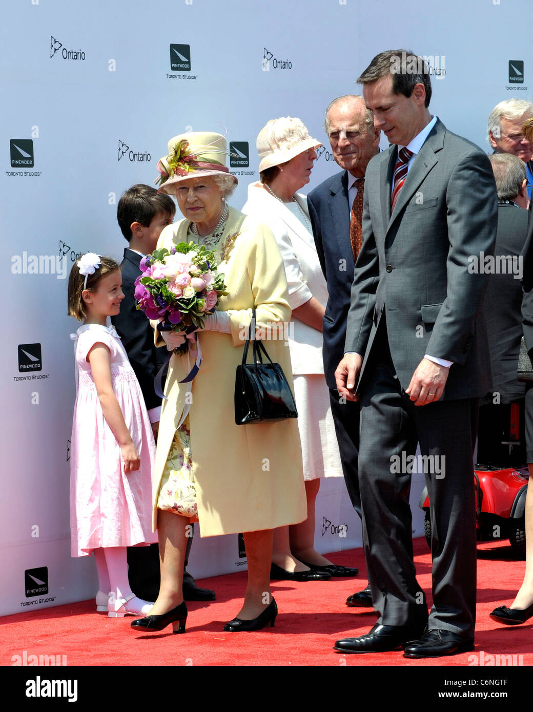 Queen Elizabeth II acommpany by Ontario Premier Dalton McGuinty arriving at the Pinewood Toronto Studios. Toronto, Canada - Stock Photo