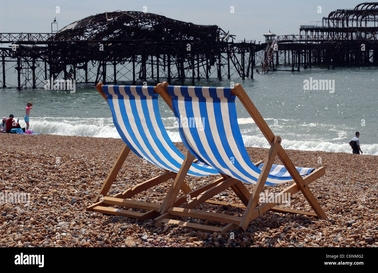 Blue striped Deckchairs on Brighton Beach near the West Pier UK Stock Photo