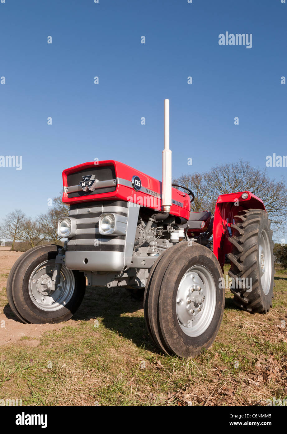 A restored vintage agricultural Massey Ferguson 135 tractor - Stock Image