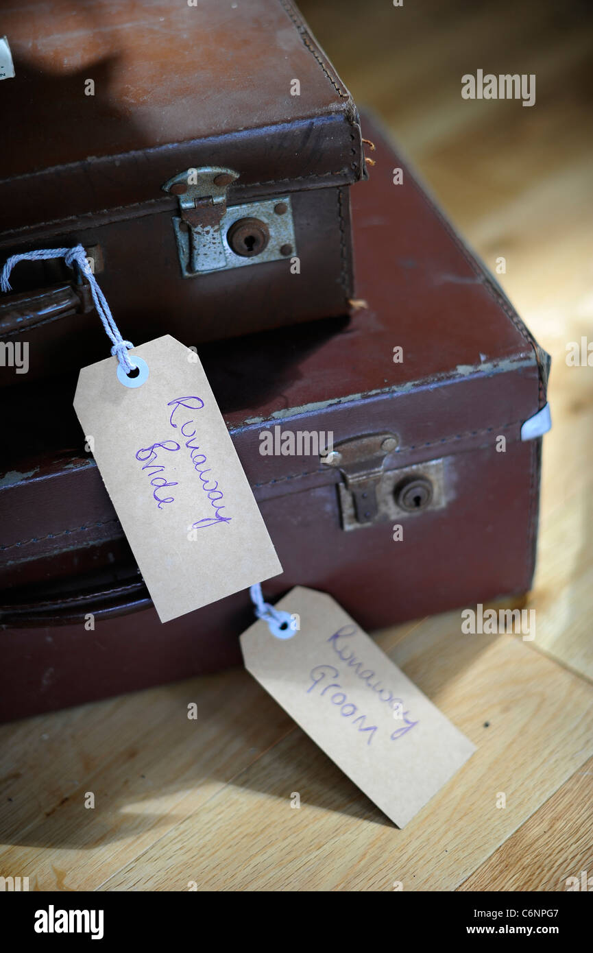 suitcases with a tag that says runaway bride wedding honeymoon Stock Photo