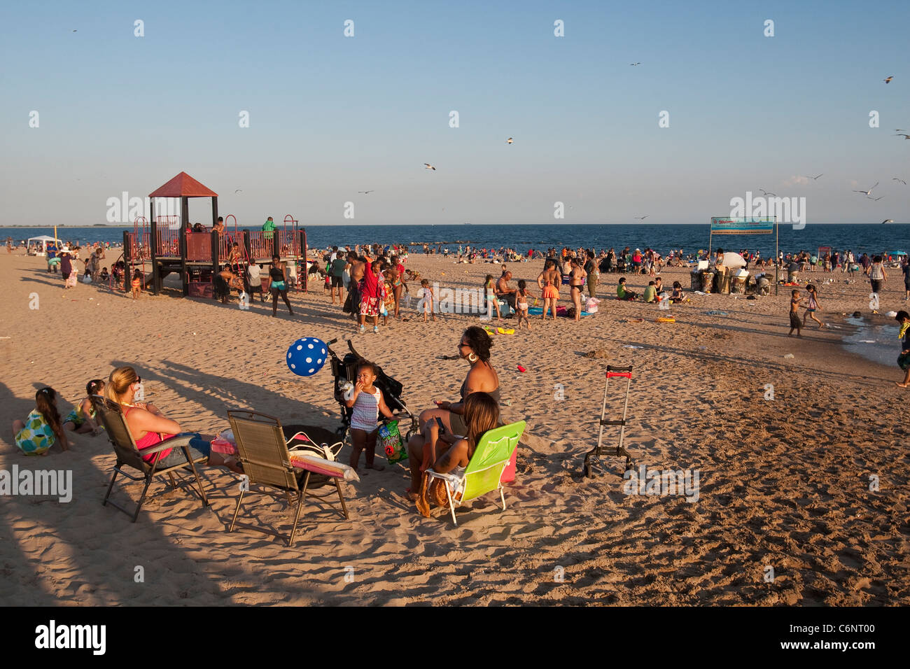 People enjoy the sun on Coney Island Beach in Brooklyn, New York ...