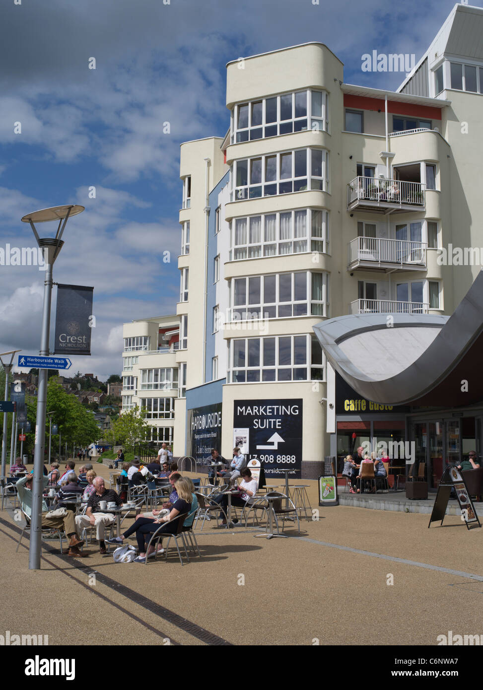 dh  DOCKS BRISTOL English cafe people sitting outdoor relaxing bristol waterfront outdoors uk harbourside quay England Stock Photo