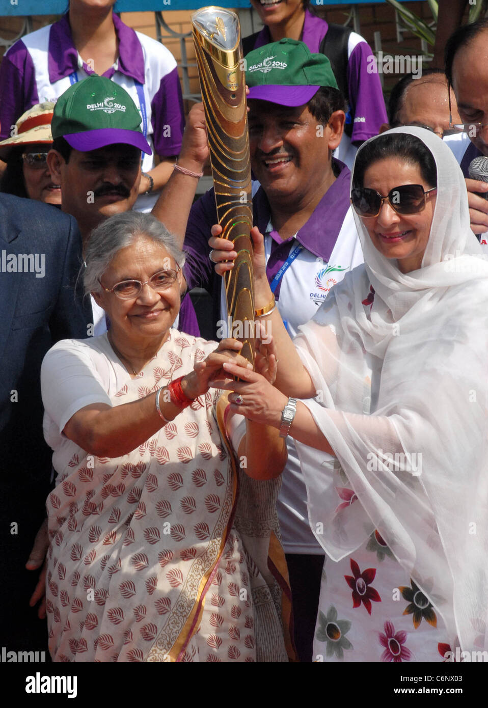 Delhi Chief Minister Sheila Dikshit hands over The Queen's Baton for 2010 Games to MoS for External Affairs Preneet Kaur after Stock Photo