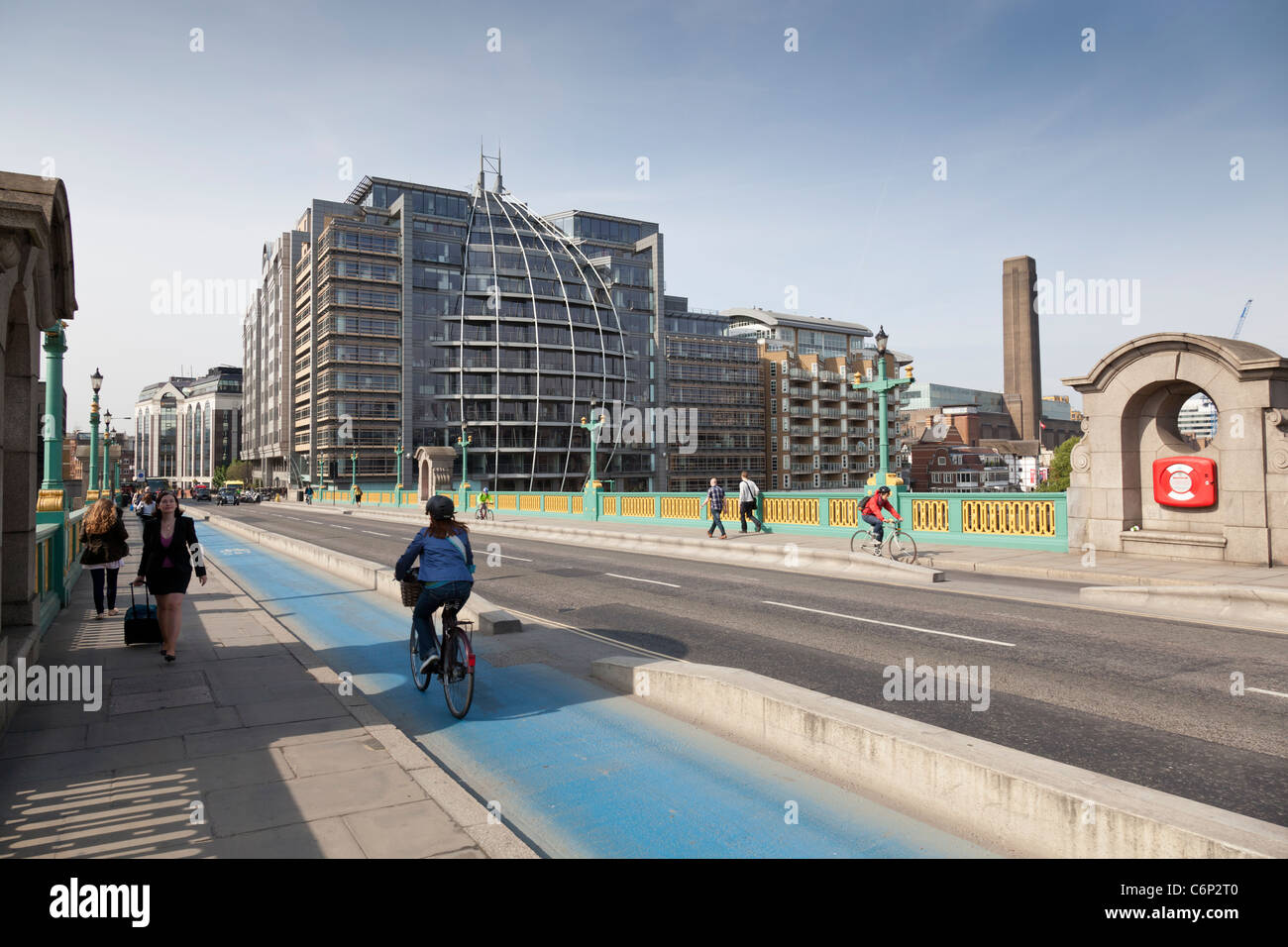 Cyclists and pedestrians make their way across Southwark Bridge, London, England. Stock Photo