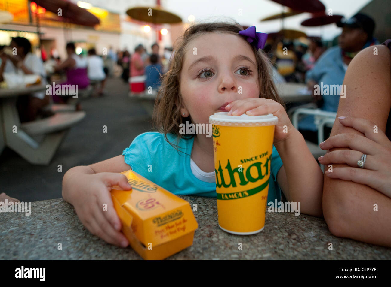 Caterina Miserandino sips some cola as she holds a hod dog at the original Nathan's Famous restaurant stands on Coney Island Stock Photo