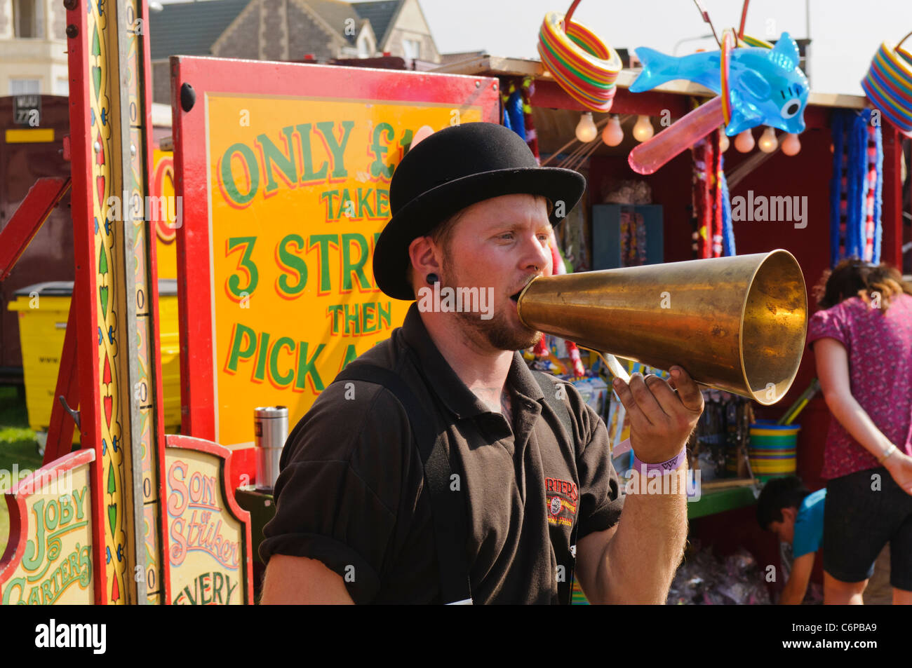 Man using an old fashioned brass loudhailer at a Victorian themed funfair Stock Photo