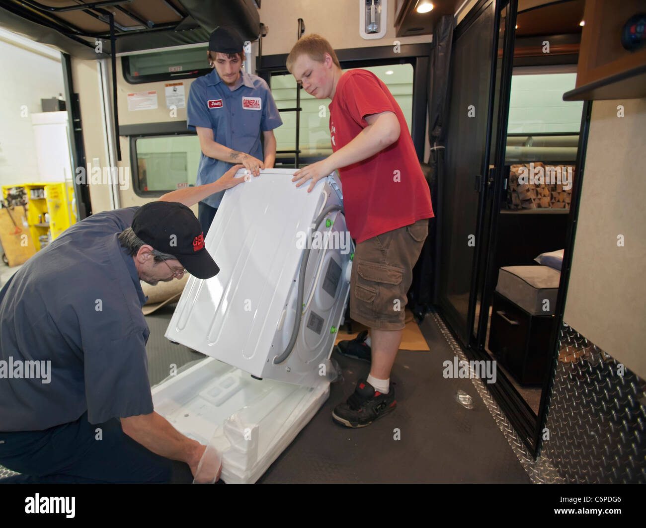 Wixom, Michigan Workers install a washing machine in a luxury RV at a