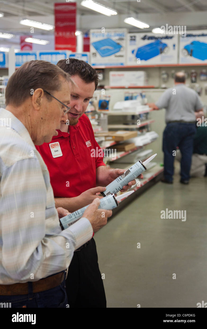 Wixom, Michigan - A worker in the parts department at a recreational vehicle dealer helps a customer find the supplies he needs. Stock Photo