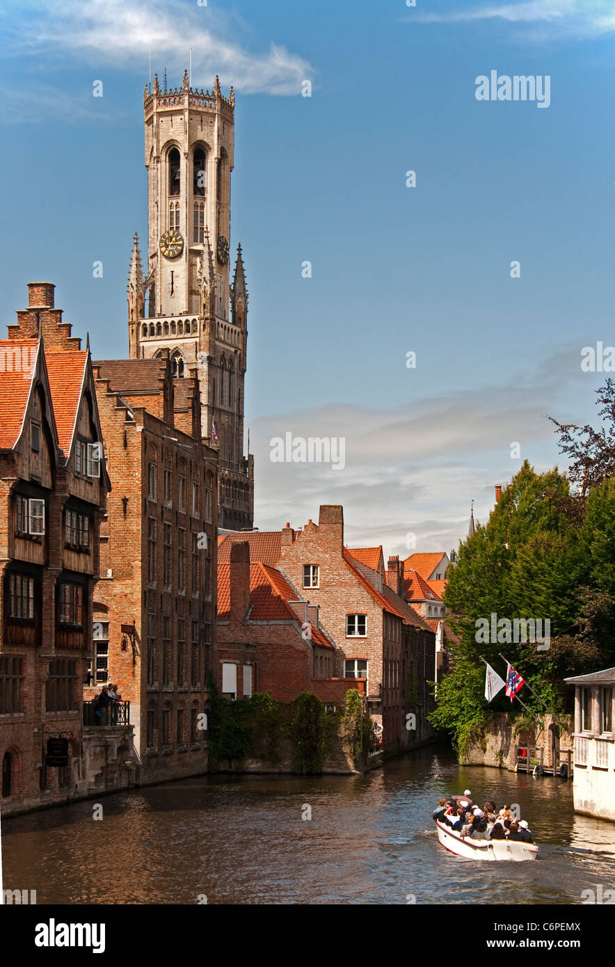 Medieval architecture of Bruges (Brugge) is dominated by the Belfort (belfry tower) as seen across canal from Dijver Stock Photo