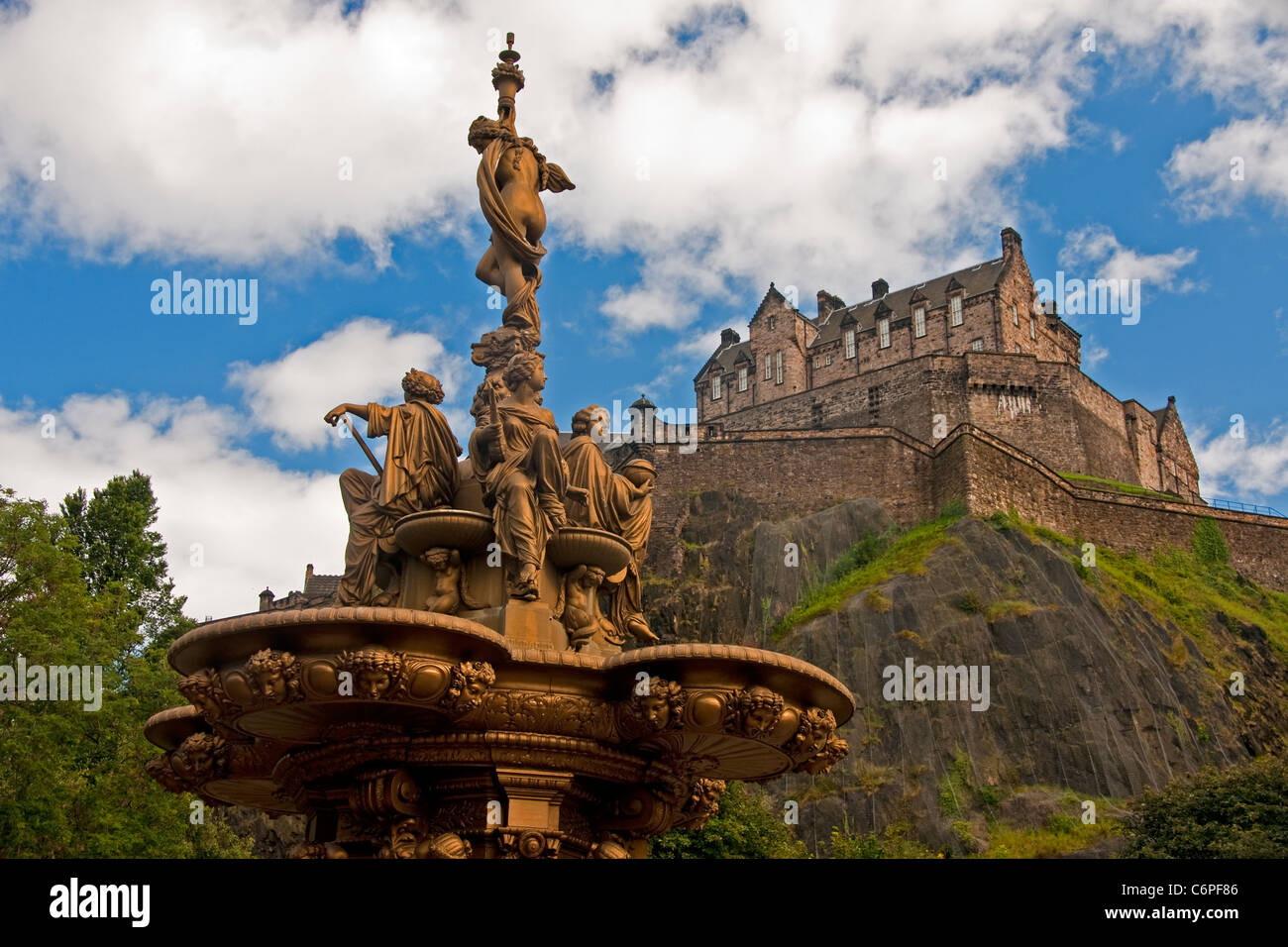 Edinburgh Castle on volcanic castle rock from West Princes Street Gardens with Ross Fountain sculpture by Jean-Baptiste Klagmann Stock Photo