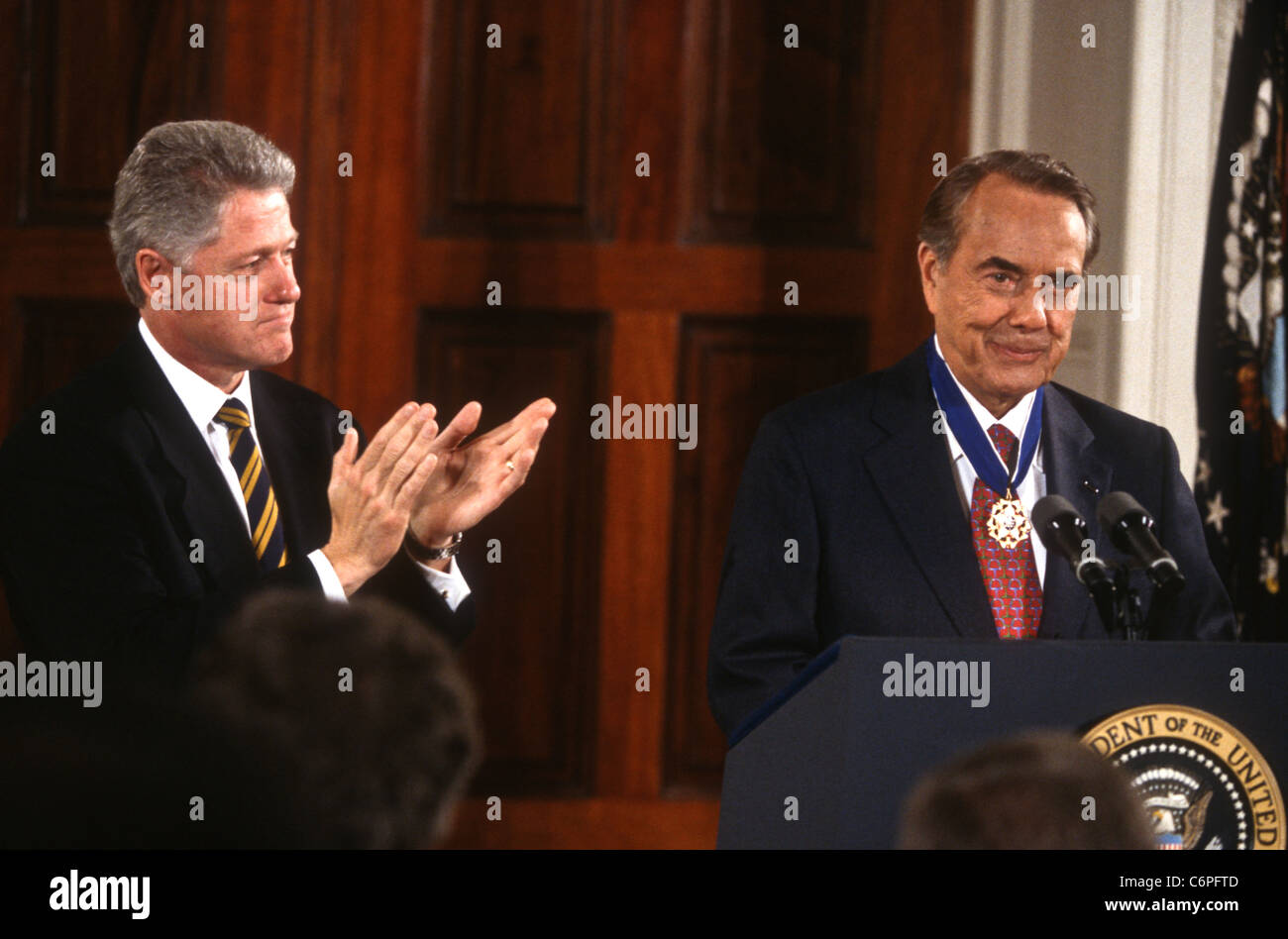 President Bill Clinton applauds Senator Bob Dole after awarding him the Medal of Freedom at the White House Stock Photo