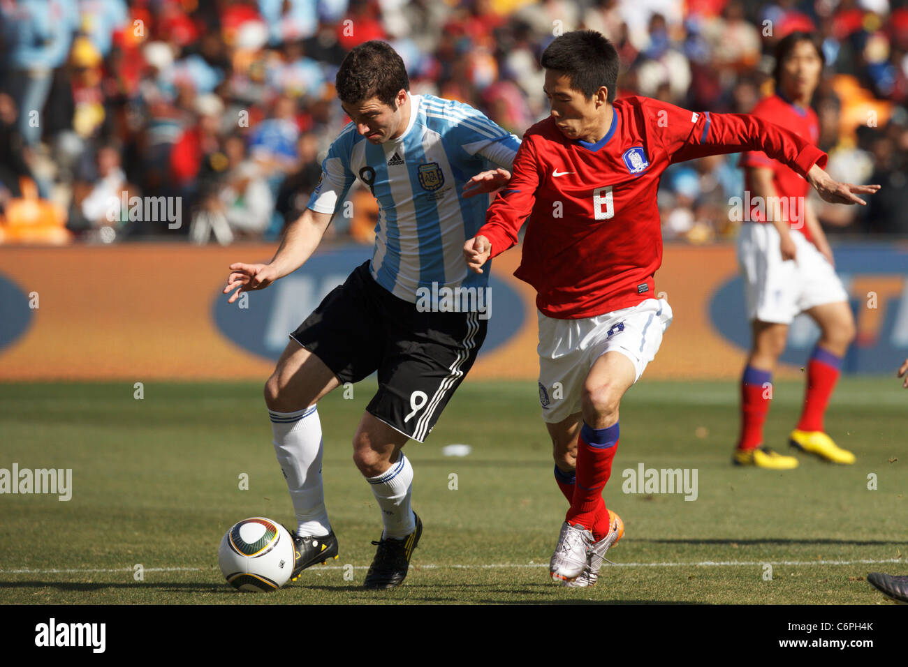 Jung Woo Kim of South Korea (r) defends against Gonzalo Higuain of Argentina (l) during a 2010 World Cup soccer match. Stock Photo