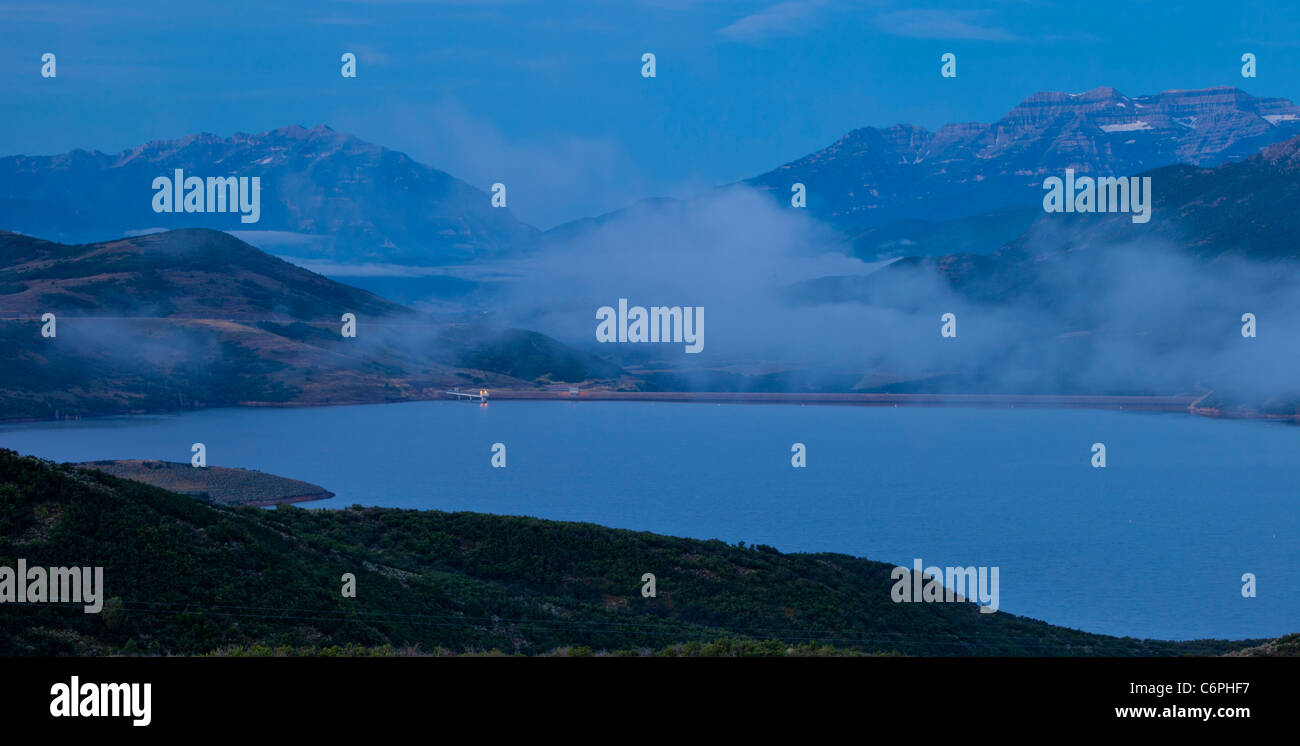 Misty pre-dawn view over Jordanelle State Park with the Wasatch and Timpanogos Mountains near Park City, Utah USA Stock Photo