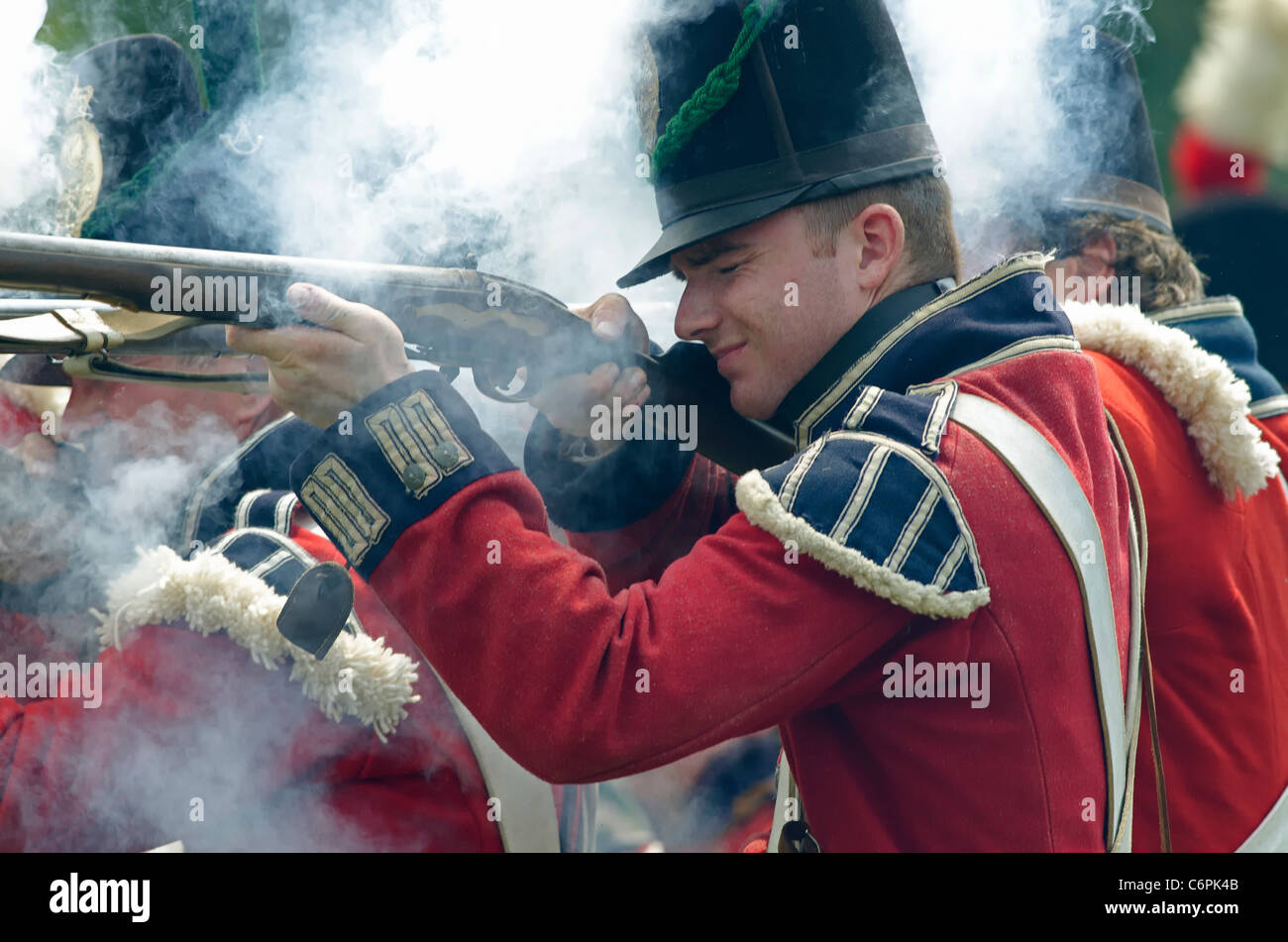 A British soldier fires his weapon at the American Infantry at the annual Siege of Fort Erie War of 1812 reenactment weekend. Stock Photo