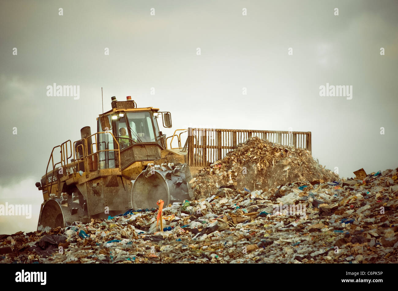 Heavy equipment pushing garbage at a sanitary landfill. Stock Photo