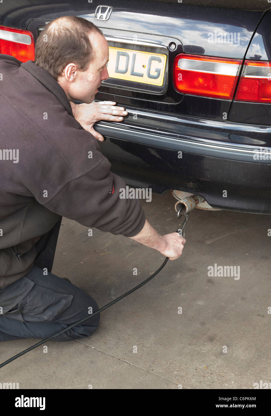 exhaust emissions test during an MOT check for a car in UK ...