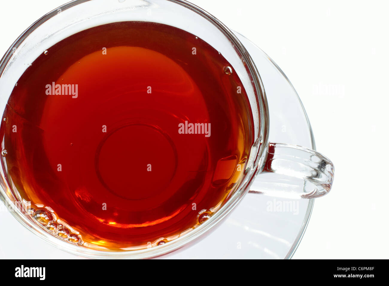 Tea in a glass cup with glass saucer Stock Photo Alamy