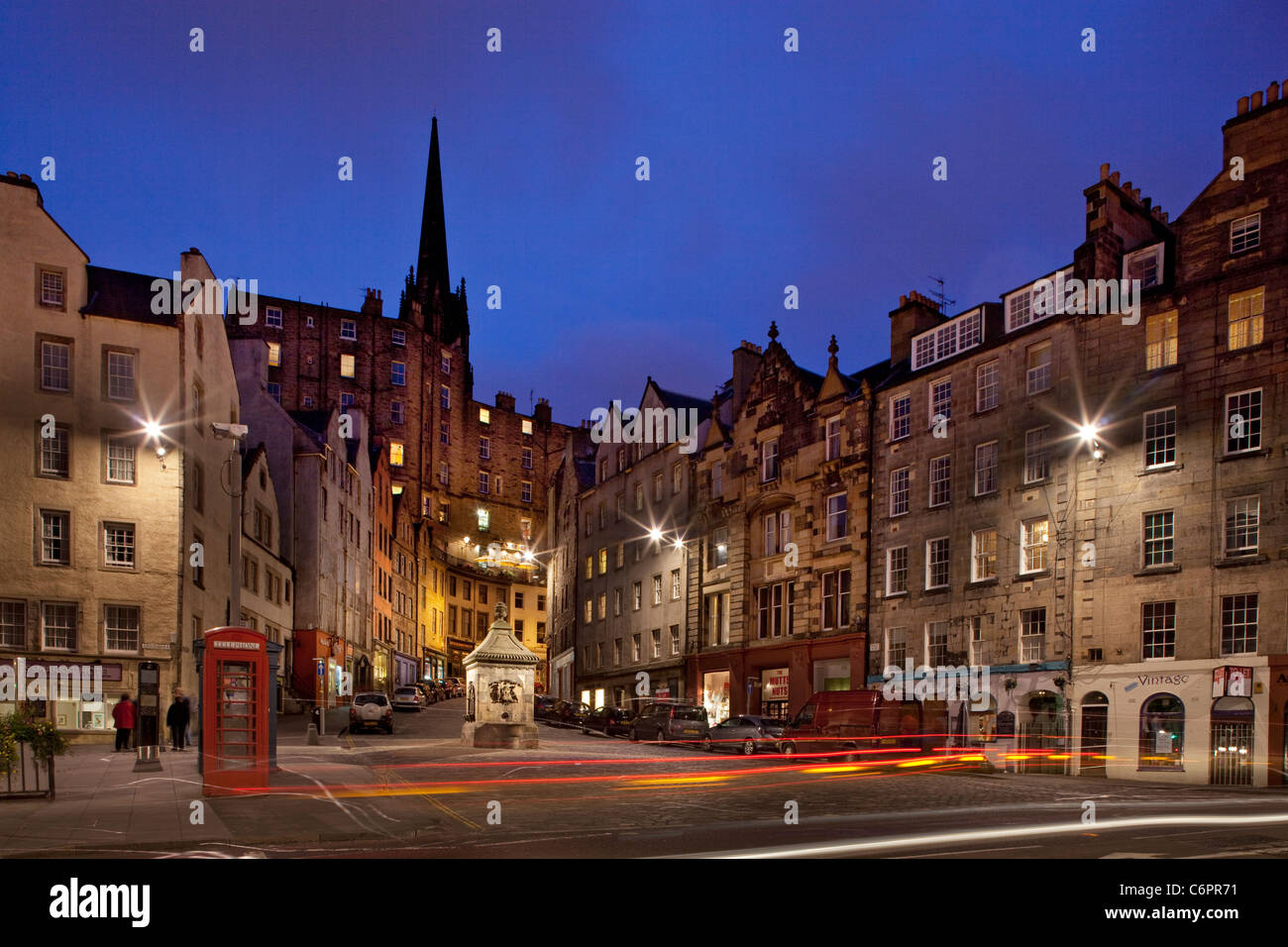 Night view up West Bow, Grassmarket to old city centre and the landmark spire of the hub, Edinburgh, Scotland. Stock Photo