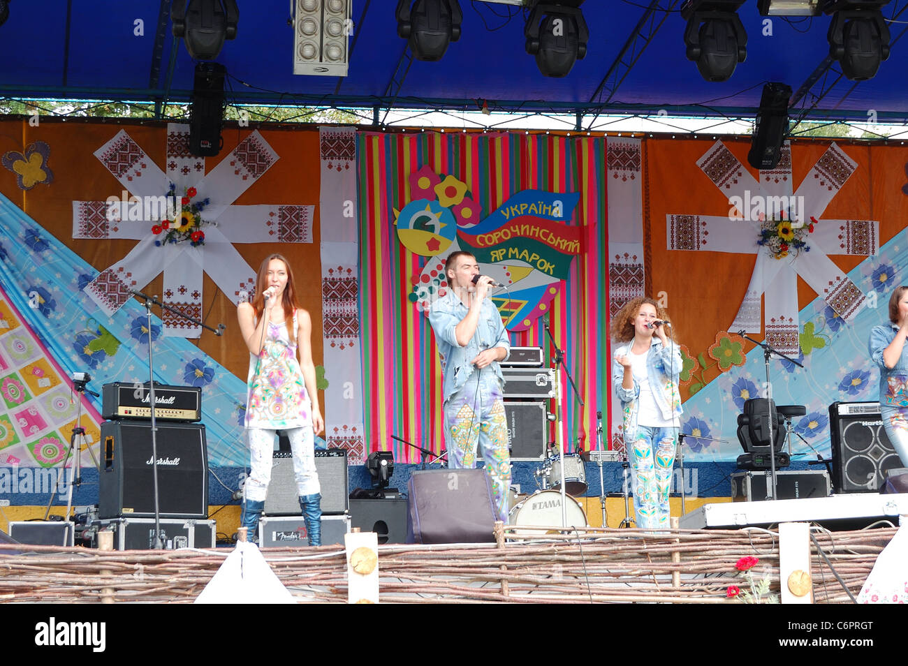 Ukrainian modern pop group in clothes with traditional ornaments performing on  stage during famous National Sorochintsi Fair Stock Photo