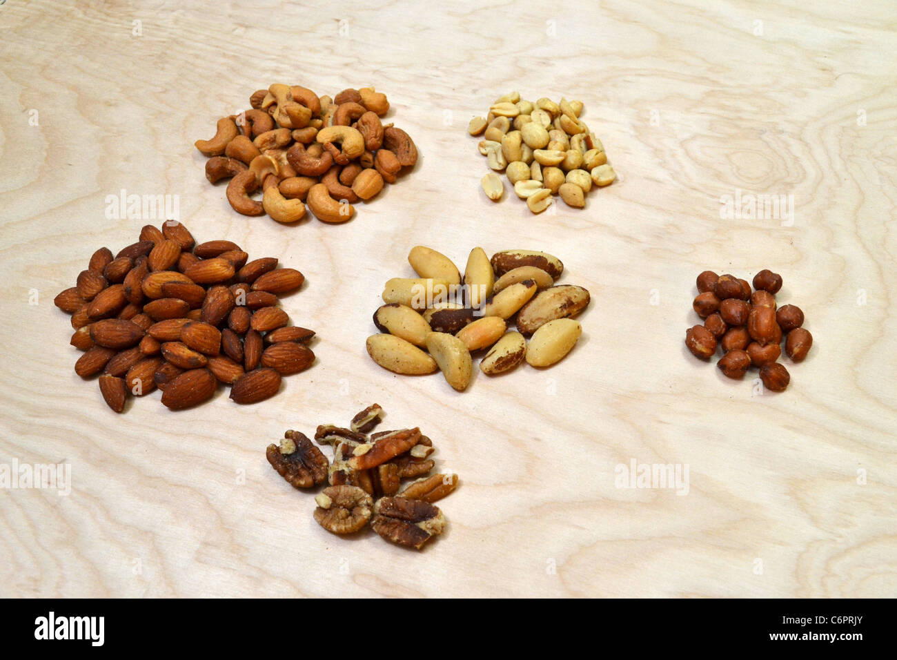 Six different piles of various types of nuts used in the making of