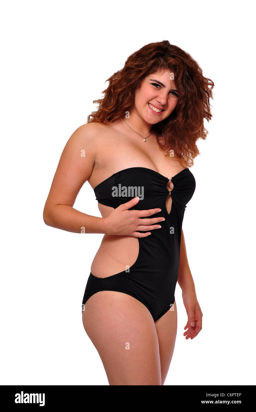 A young 20 something swimsuit model is posing on a black background. Stock Photo
