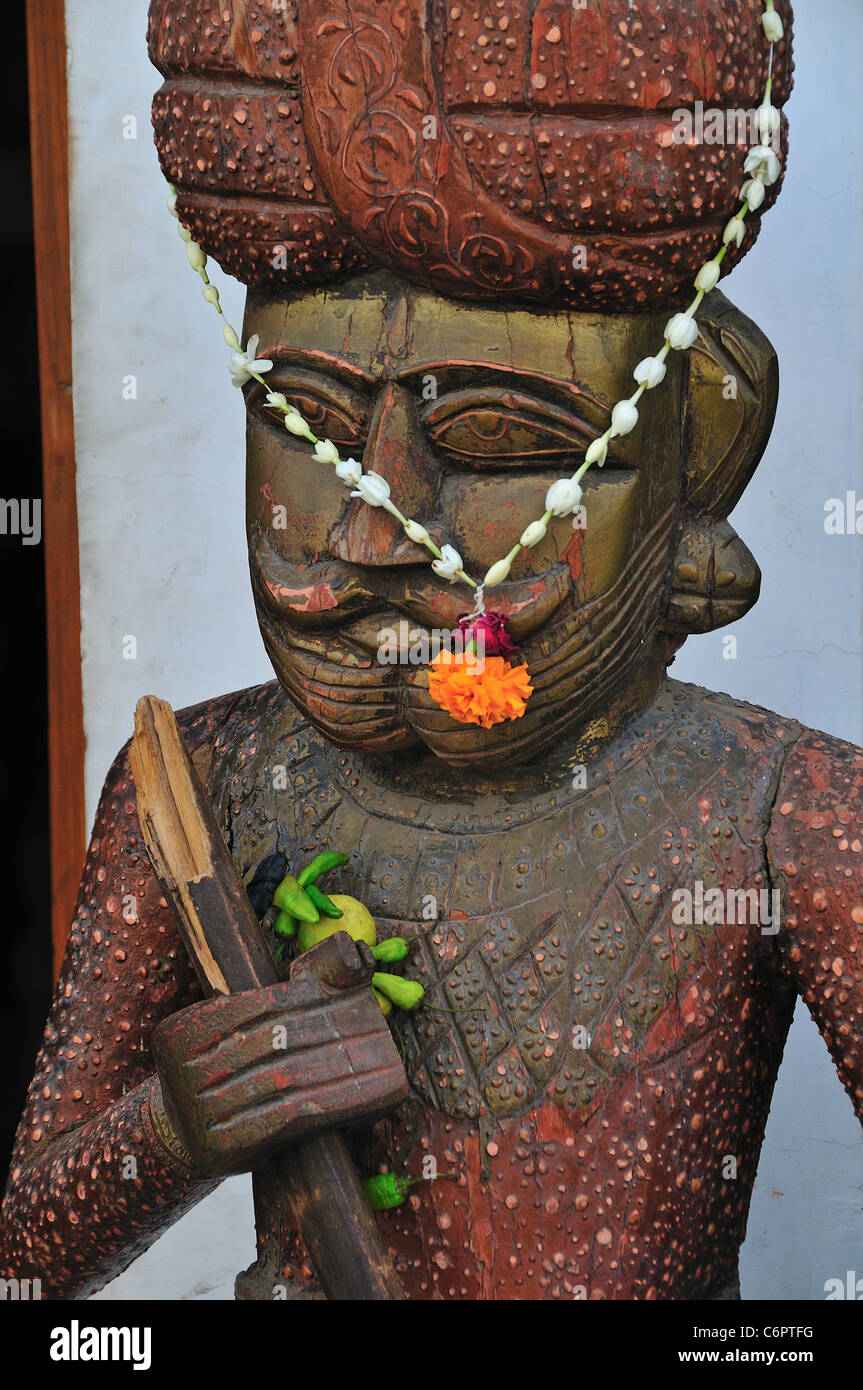 Wooden statue at the entrance of the restaurant Stock Photo