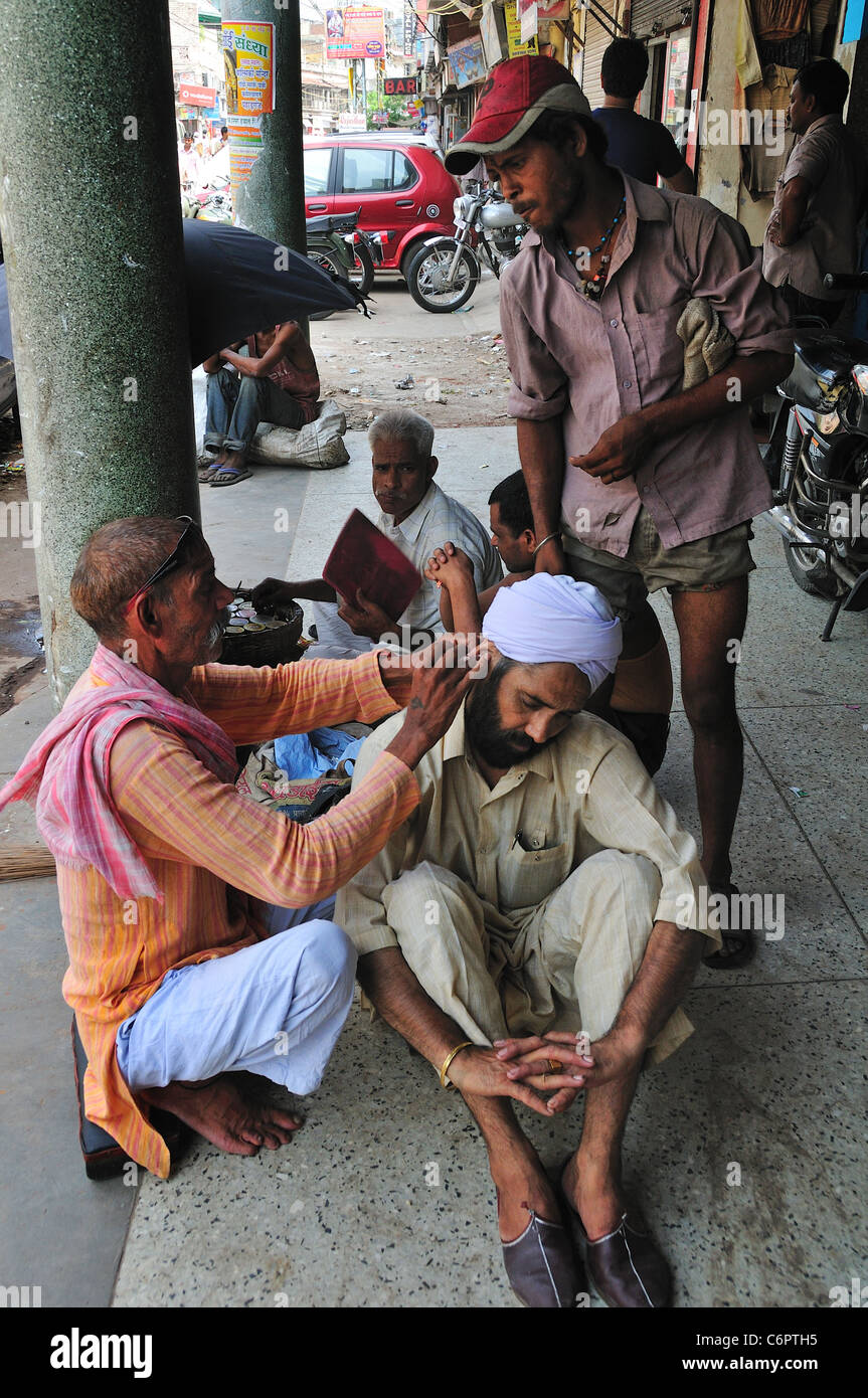 There are many professional ear cleaner on the street in India Stock Photo