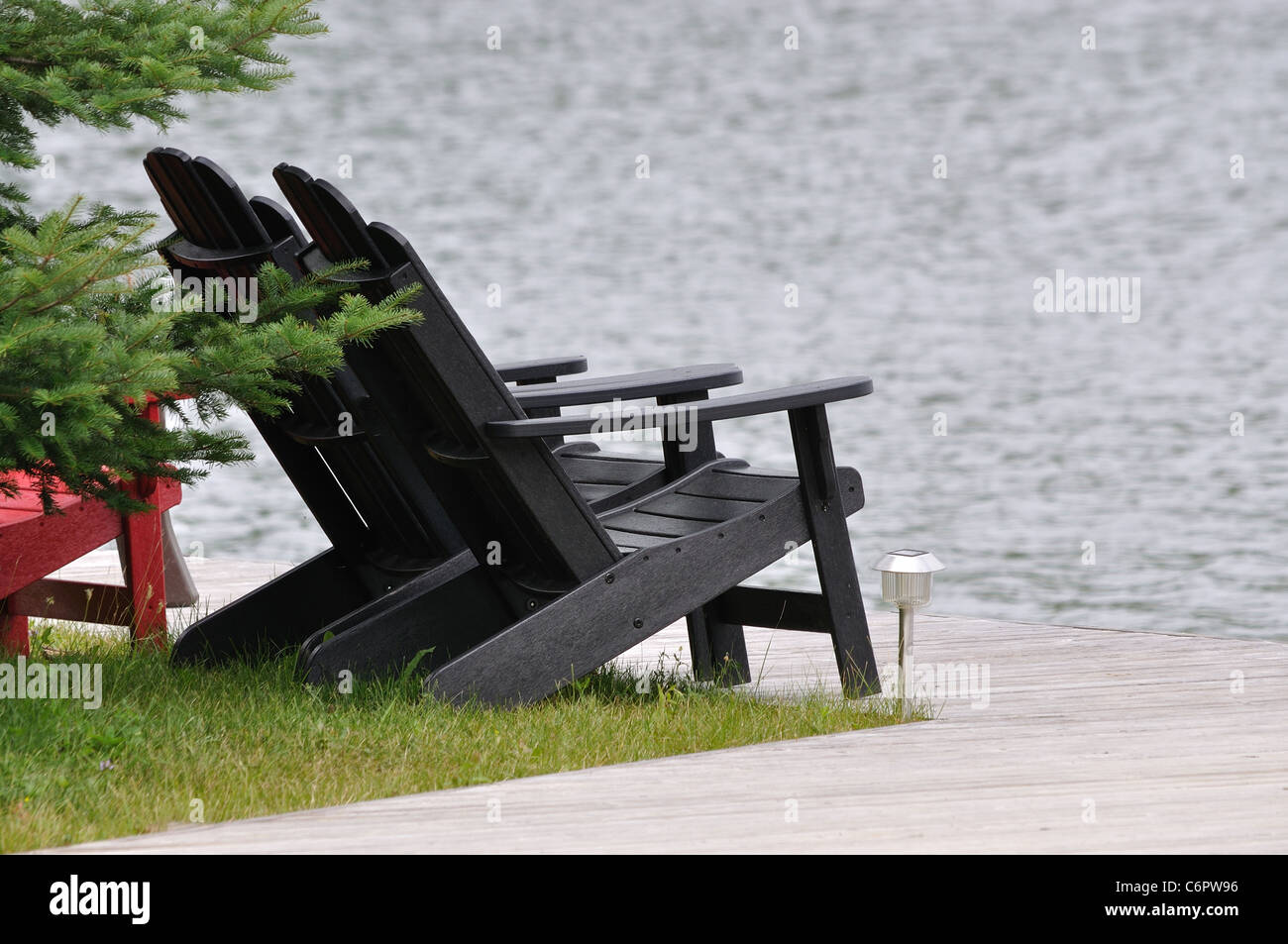 Black Muskoka Cottage Chairs on Deck Stock Photo Alamy