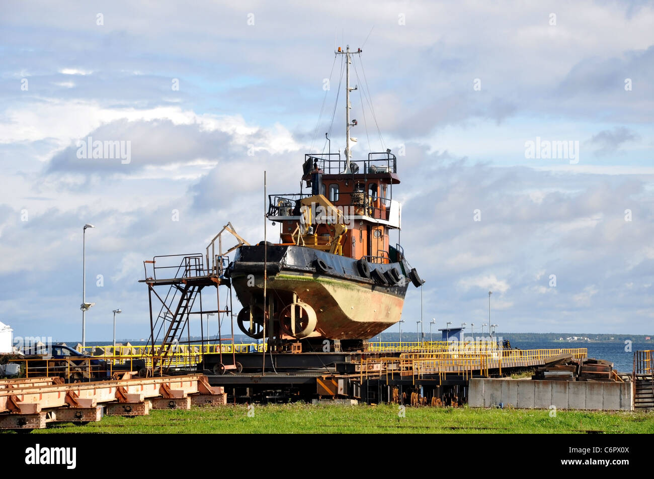 The small marine vessel is lifted from water on a building berth Stock Photo