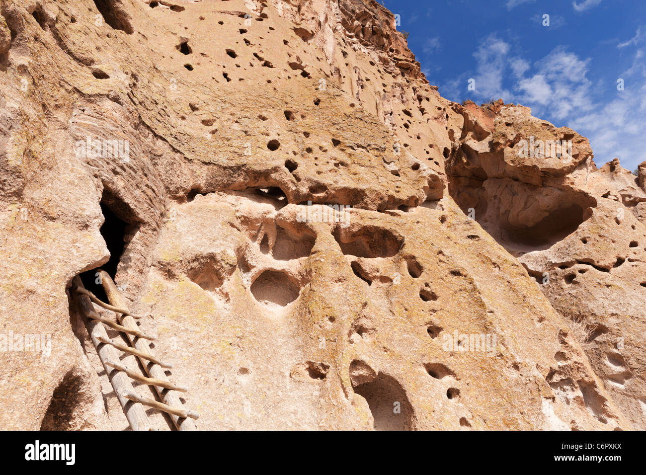 Rocky canyon wall and ladder to historic cliff dwelling - Bandelier National Monument, New Mexico, USA. Stock Photo