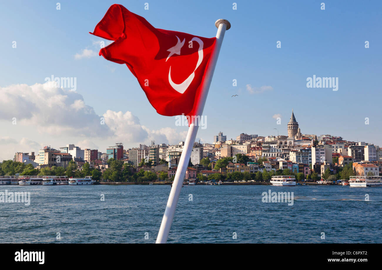 Galata Tower, with a foreground Turkish flag of a steamer, Beyoglu, Istanbul, Turkey Stock Photo