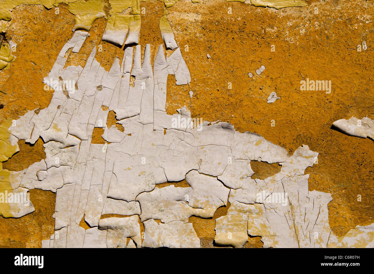 Background of the old painted wall with the loose paint. Stock Photo