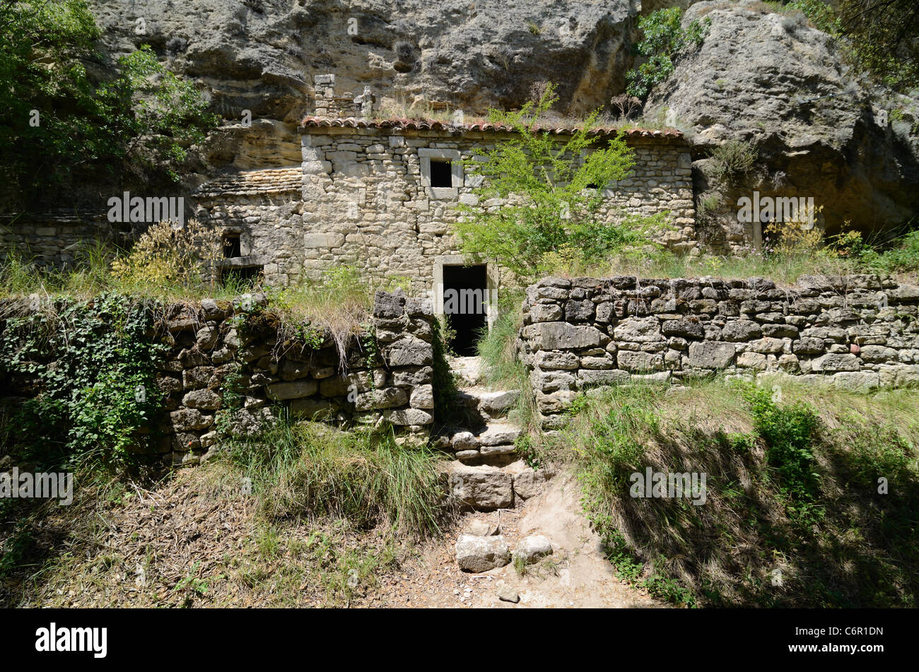 Troglodyte House built into the Cliff in the Abandoned or Deserted Village of Barry Drôme Provence France Stock Photo