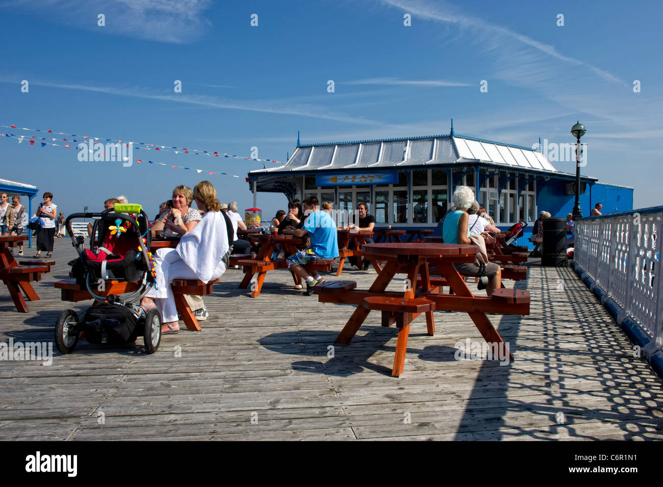 Tourists sitting at a cafe on Llandudno Pier Stock Photo