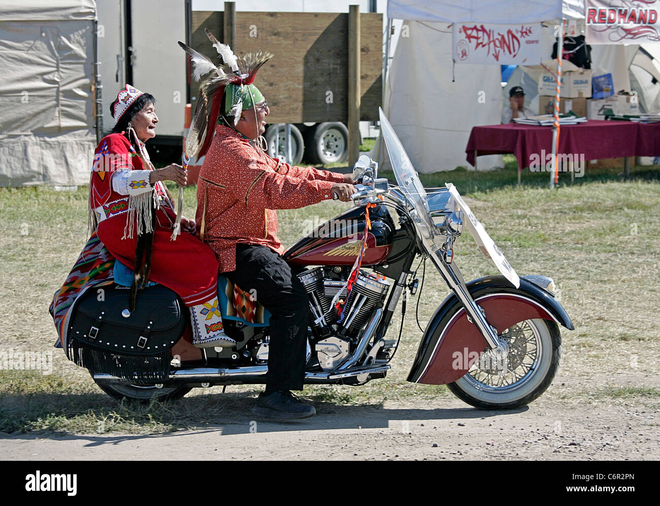 Grand Marshall of the parade held during the annual Shoshone-Bannock Festival with a passenger on an Indian brand motorcycle. Stock Photo
