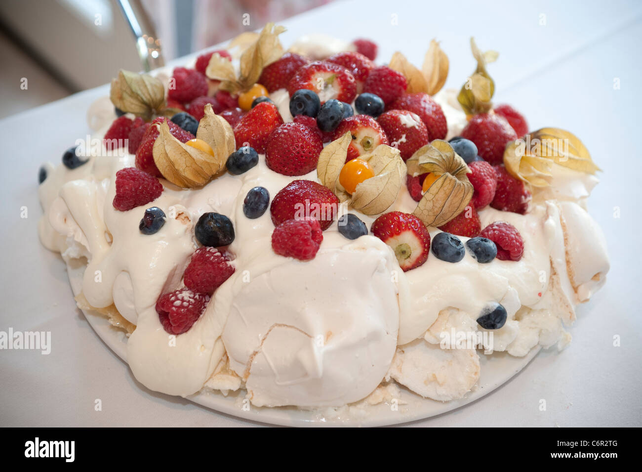 Pavlova desert with summer fruits such as strawberries, raspberries